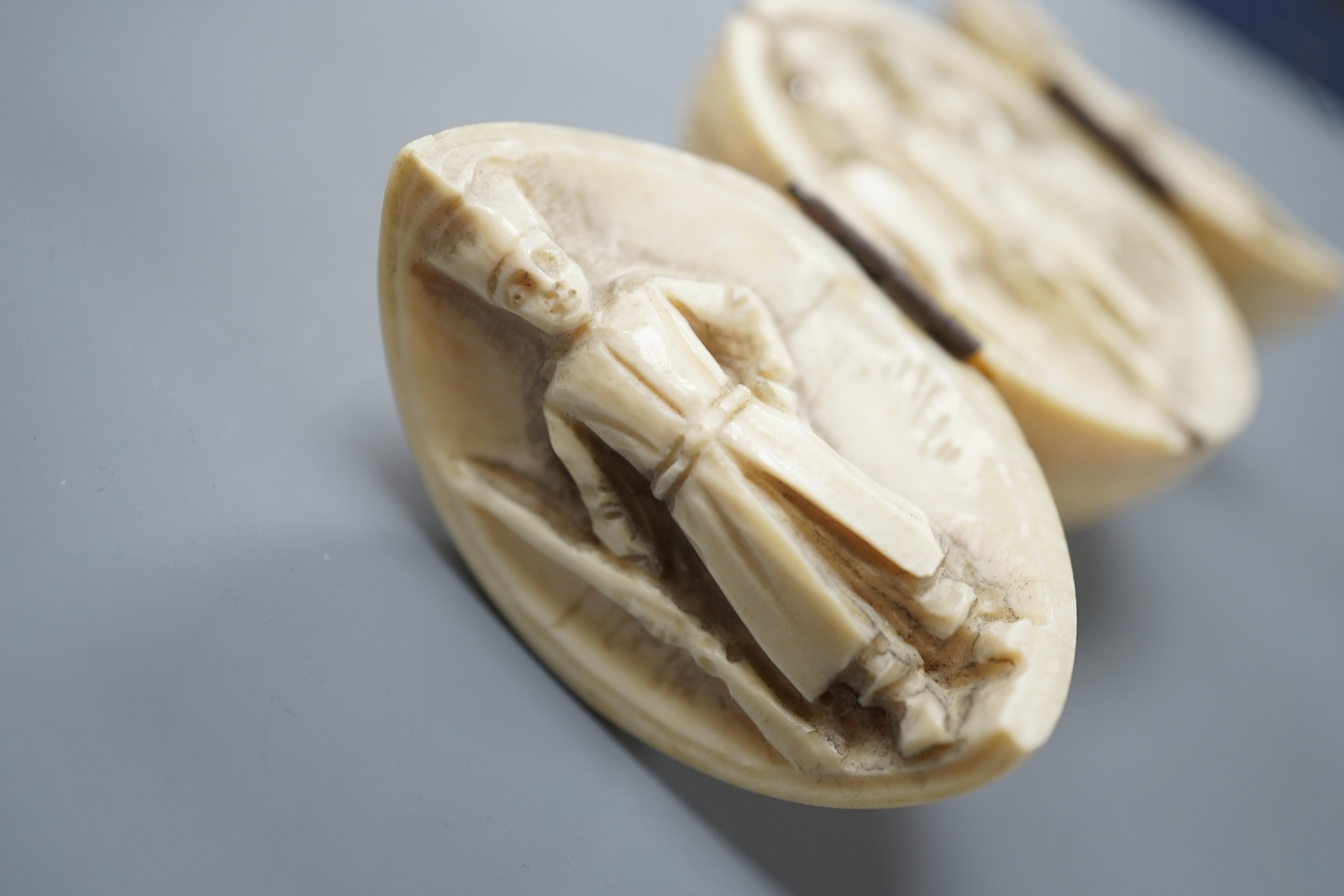 A 19th century Dieppe ivory globular triptych, possibly depicting Crimean war figures, 5.4cm diameter closed